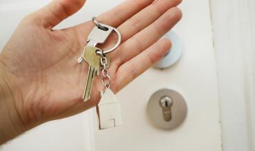 a hand holding a house key 