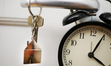 A clock, a key and a door handle