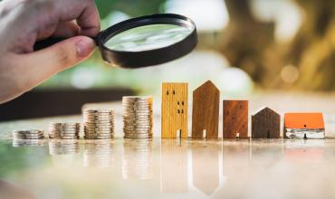 apartments and coins with magnifying glass over them