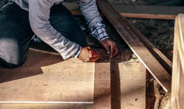 a man measuring wood