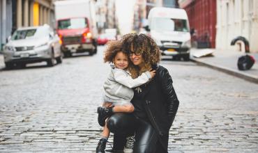 child and woman hugging