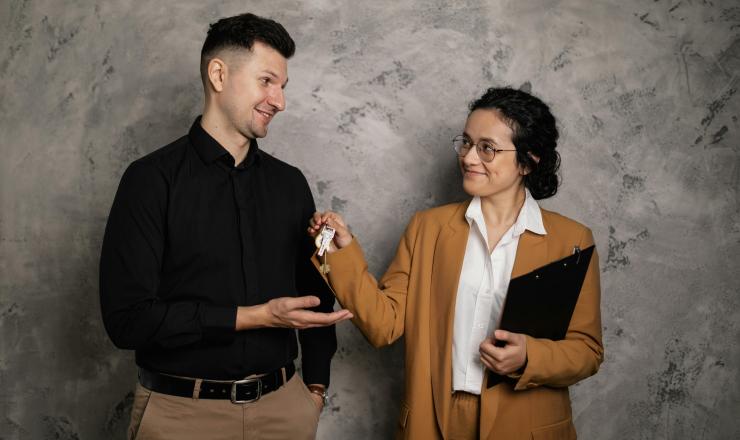 Real Estate Agent giving keys to first-time home buyer