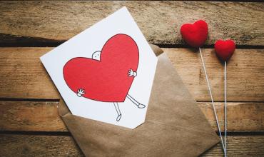 An envelope with a card in it with a heart on it
