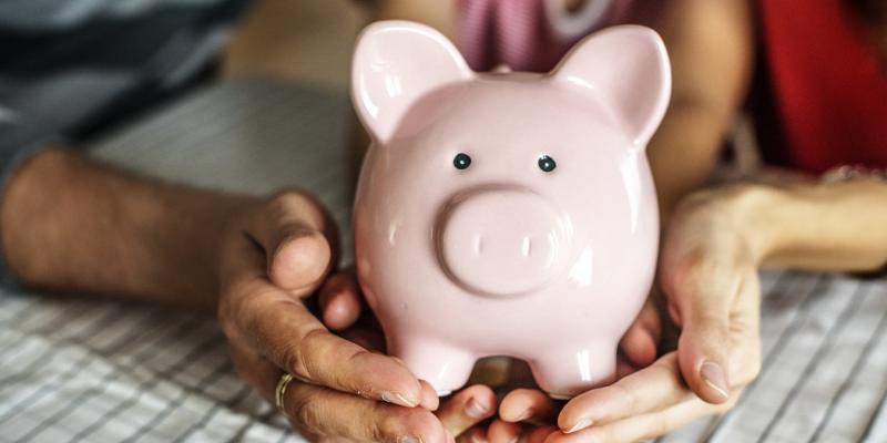 Hands holding a piggy bank