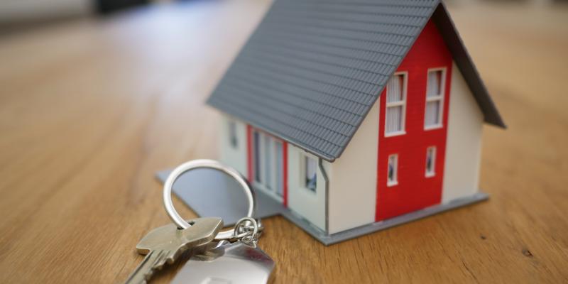 A toy house on a table with keys