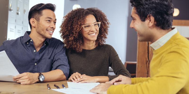 a couple sitting with a lender 