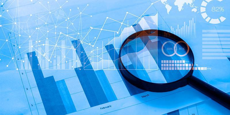 A magnifying glass over bar graphs