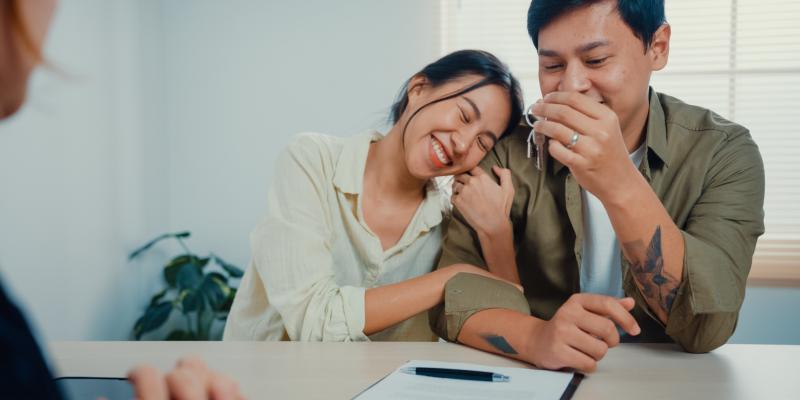 A happy couple sitting at a desk