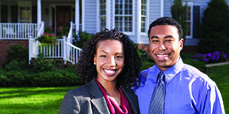 Couple in front of home