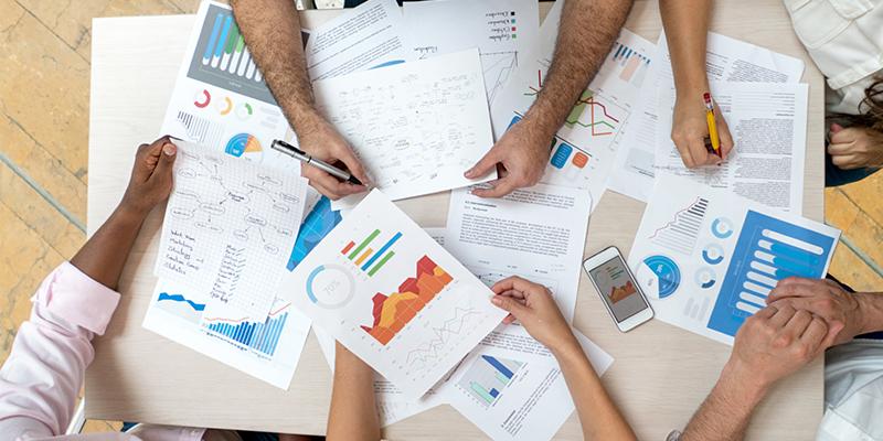 Millennials and Baby Boomers Increasingly Shape Housing Demand a group of individuals at a desk working over some documents