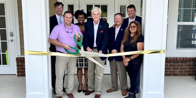 Photo of ribbon cutting with giant scissors 
