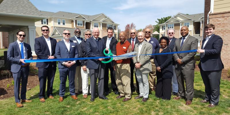 attendees cutting a ribbon at Kitkwood Crossing