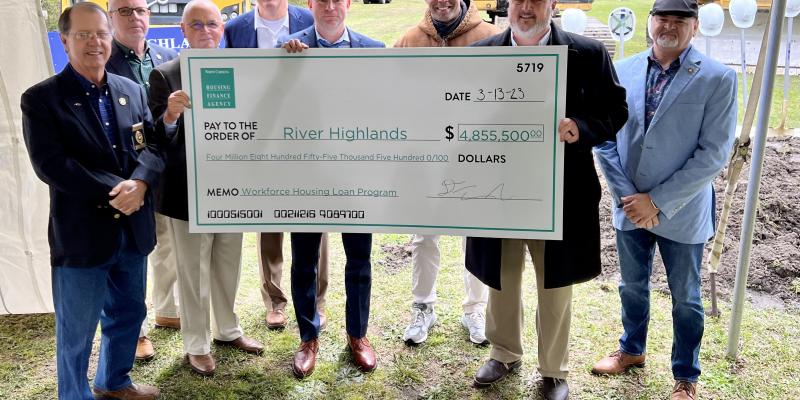 People holding up a giant check