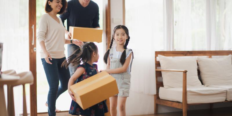 More North Carolinians Now Eligible for Affordable Mortgages and $15K Down Payment Assistance A family walking into their new home with boxes