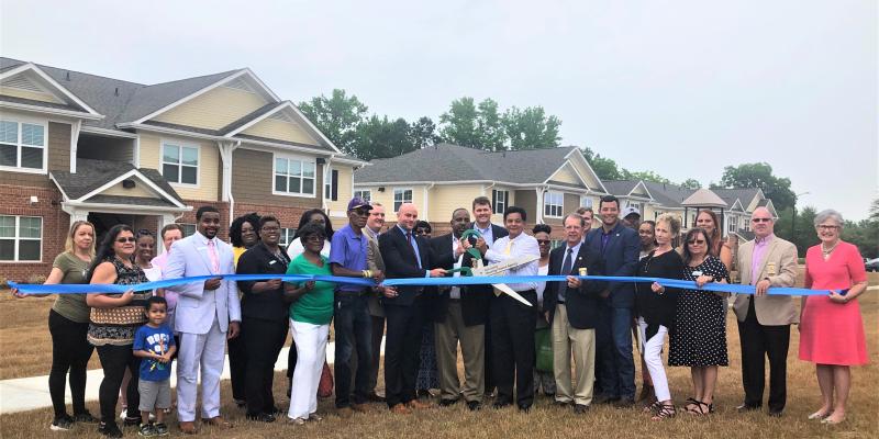 Group of people cutting a ribbon