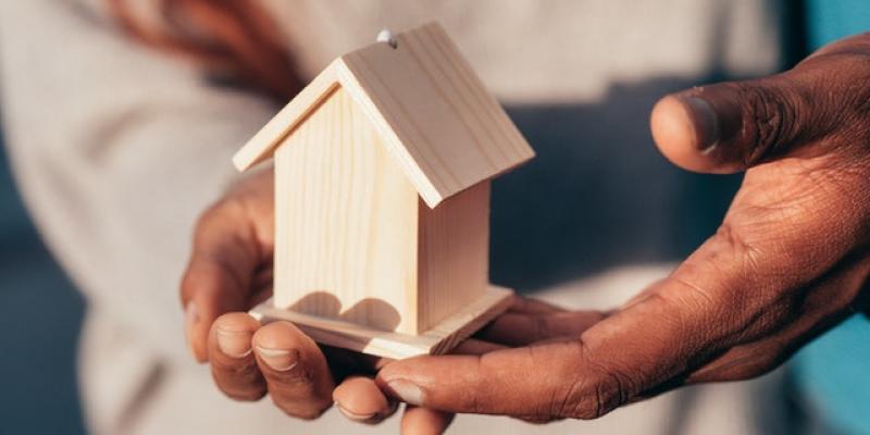 New Data, Federal Construction Standards and Hurricane Helene Impacts: Manufactured Housing in 2024 A person holding a small model of a home in their hands