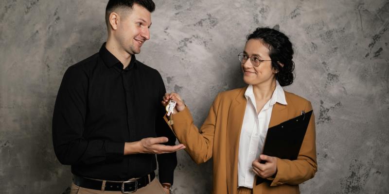 Real Estate Agent giving keys to first-time home buyer