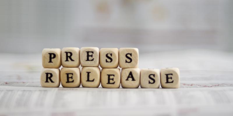 Scrabble letters spelling out "press release"